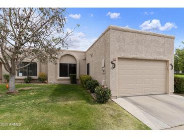 Inviting single-story home featuring a well-manicured lawn and a convenient two-car garage at 755 S Arrowwood Way, Mesa, AZ 85208