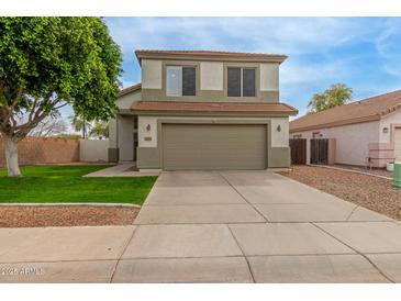 Two-story home with a large garage and well-maintained lawn at 927 E Baylor Ln, Gilbert, AZ 85296