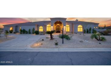 Beautiful single-story home featuring arched windows and a well-manicured front yard at 9826 N 131St St, Scottsdale, AZ 85259