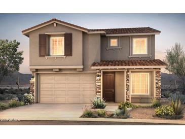 Charming two-story home with a tile roof, stone accents, and a well-manicured desert landscape at 13479 W Cassia Trl, Peoria, AZ 85383