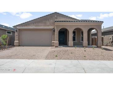 Charming single-story home featuring a welcoming arched entryway and a two-car garage at 13512 W Copperleaf Ln, Peoria, AZ 85383