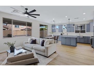 Bright open-concept living room and kitchen with modern finishes and natural light at 19862 E Carriage Way, Queen Creek, AZ 85142