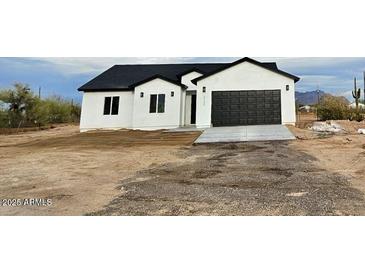 Newly constructed single-story home features a spacious two-car garage and desert landscaping at 2133 N Valley Dr, Apache Junction, AZ 85120