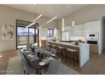 Bright, modern kitchen with sleek countertops, a large island, and expansive windows offering scenic views at 39332 N Old Stage Rd, Cave Creek, AZ 85331