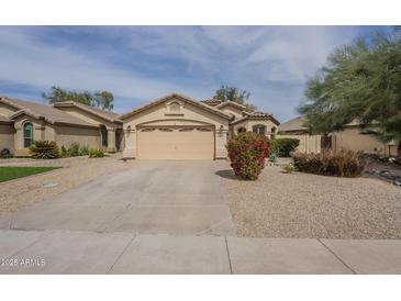 Charming single-story home featuring a well-maintained yard and attached two-car garage at 486 E Devon Dr, Gilbert, AZ 85296