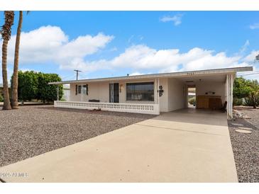 Charming single-story home with a front porch, driveway, and desert landscaping, ideal for comfortable living at 5463 E Albany St, Mesa, AZ 85205