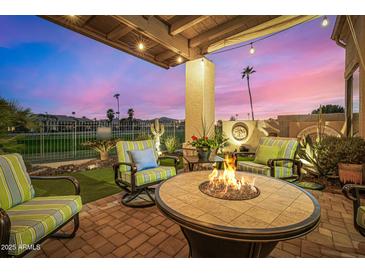 Inviting backyard patio featuring a fire pit, comfortable chairs, and lush landscaping for serene outdoor living at 6202 E Mckellips Rd # 46, Mesa, AZ 85215