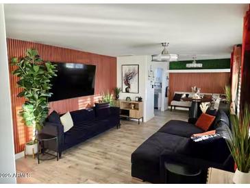 A stylish living room featuring a large flat-screen TV and elegant decor at 2827 N 69Th Pl, Scottsdale, AZ 85257