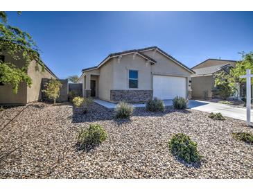 Charming single-story home with a two car garage, stone accents, and low-maintenance landscaping at 36217 N Urika Dr, San Tan Valley, AZ 85140