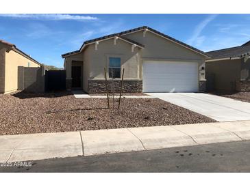 Charming single-story home featuring a neutral color scheme, low-maintenance landscaping, and a convenient two-car garage at 36217 N Urika Dr, San Tan Valley, AZ 85140