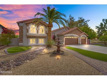 Charming two-story home with a desert landscape, water fountain, and three-car garage at 8781 S Mill Ave, Tempe, AZ 85284