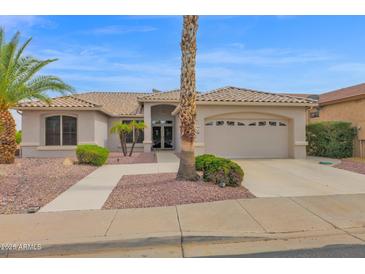 Charming single-story home with desert landscaping, palm trees, and a two-car garage in a desirable community at 17443 N Goldwater Dr, Surprise, AZ 85374