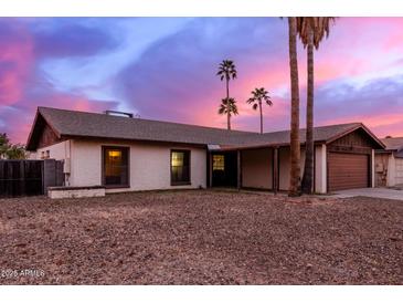 Charming single story home with a large front yard and attached two car garage at 3037 W Libby St, Phoenix, AZ 85053