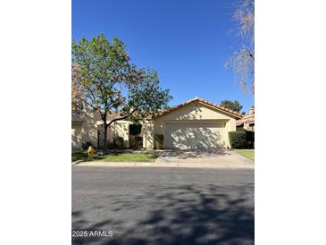 Charming single-story home with a well-manicured front lawn and inviting curb appeal at 50 W Calle De Arcos --, Tempe, AZ 85284