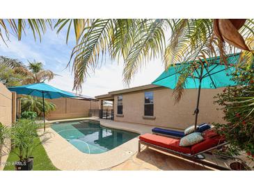 A refreshing backyard pool with lounge chairs and a relaxing patio area, perfect for outdoor living at 6796 W Evergreen Ter, Peoria, AZ 85383