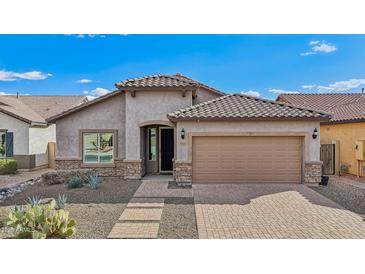 Charming single-story home with a tile roof, desert landscaping, and a spacious two-car garage at 10841 W Nosean Rd, Peoria, AZ 85383