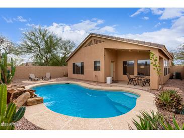 Beautiful backyard with a pool and landscaping, perfect for relaxing and entertaining at 12787 S 175Th Ave, Goodyear, AZ 85338