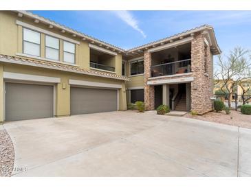 Stunning two-story condo with stone accents, a two-car garage, and a private balcony in a desert community at 21320 N 56Th St # 2005, Phoenix, AZ 85054