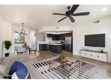 Open floor plan with a kitchen featuring stainless steel appliances and a cozy dining area at 280 S Evergreen Rd # 1336, Tempe, AZ 85288