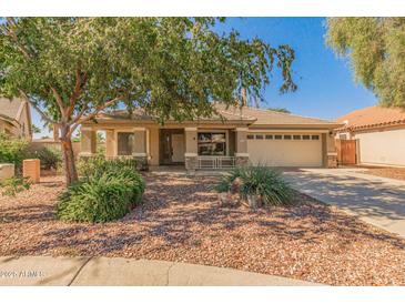 Single-story home featuring a well-manicured front yard, tile roof, and covered porch at 29900 N Maravilla Dr, San Tan Valley, AZ 85143