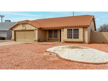 Charming single-story home with a well-manicured desert landscape and a red tile roof at 4622 E Fairbrook Cir, Mesa, AZ 85205