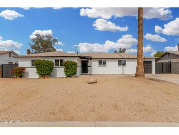 Charming single-story home featuring a low-maintenance landscape and attached garage at 5716 W Hazelwood St, Phoenix, AZ 85031