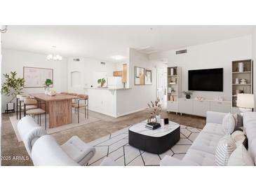 Bright, open-concept living area with modern furnishings and a dining space at 6920 E 4Th St # 209, Scottsdale, AZ 85251