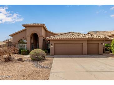 Charming single-story home boasts a well-manicured desert landscape and a three-car garage at 9393 E Hunter Ct, Scottsdale, AZ 85262