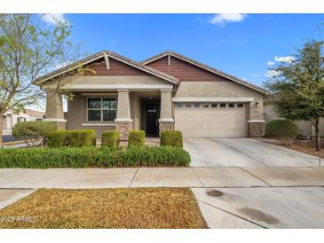 Charming single-story home with a well-manicured front yard and a two-car garage at 9932 E Tumbleweed Ave, Mesa, AZ 85212