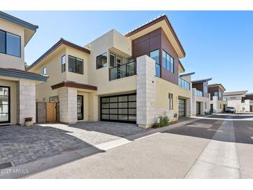 Contemporary home featuring a two-car garage, sleek lines, and a stone exterior at 1 Easy St # 3, Carefree, AZ 85377