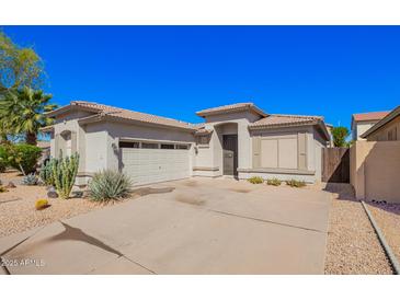 Single-story home showcasing a desert landscape, private drive, and a two-car garage, complemented by a neutral color palette at 220 W Wood Dr, Chandler, AZ 85248