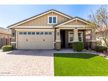 Charming single-Gathering home with a manicured front yard, brick driveway, and a two-car garage at 2807 W Canada De Oro Rd, Queen Creek, AZ 85144