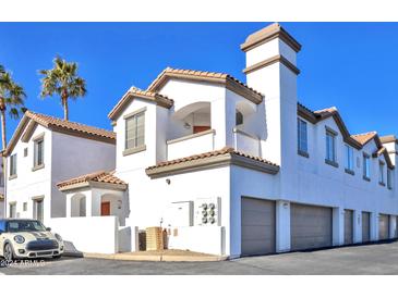 Charming townhome featuring a private balcony, two-car garage and terracotta roof, perfect for low-maintenance living at 2992 N Miller Rd # A202, Scottsdale, AZ 85251