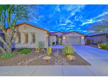 Charming single-story home with desert landscaping, two-car garage and beautiful desert plants at 30550 N 125Th Dr, Peoria, AZ 85383