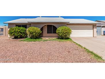 Charming single-story home with low-maintenance landscaping and a two-car garage at 716 W Nopal Pl, Chandler, AZ 85225