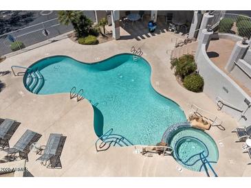Aerial view of a community pool, hot tub and lounge chairs with desert landscaping and stair access to other amenities at 9750 N Monterey Dr # 50, Fountain Hills, AZ 85268