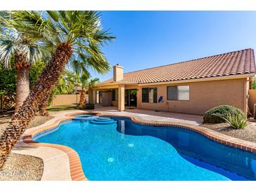 Stunning backyard pool and spa with mature landscaping and plenty of space for entertaining at 1182 E Harrison St, Gilbert, AZ 85295