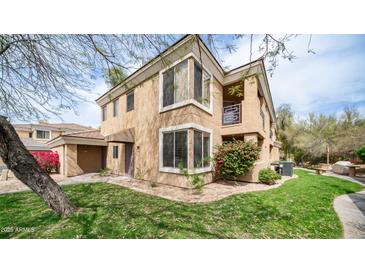 Beautiful multi-level home featuring a landscaped yard, bay windows, and a small balcony at 1411 E Orangewood Ave # 123, Phoenix, AZ 85020