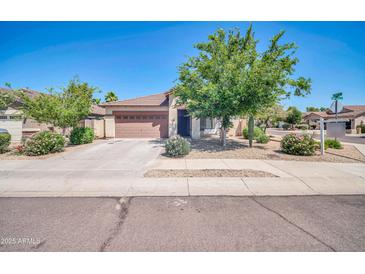 Charming single-story home features a well-maintained lawn and a two-car garage at 17008 W Sonora St, Goodyear, AZ 85338