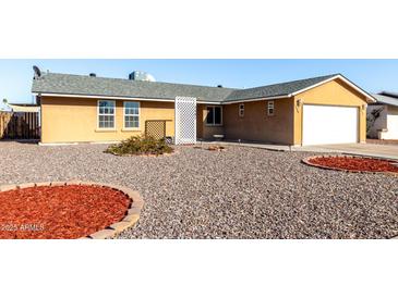 Charming single-story home with a two-car garage and low maintenance desert landscaping at 2581 E Commonwealth Cir, Chandler, AZ 85225