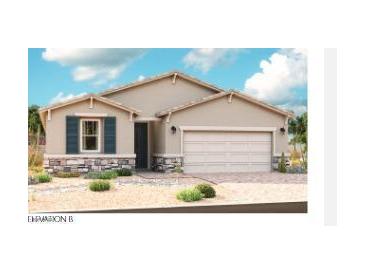 Charming single-story home featuring stone accents, a two-car garage, desert landscaping and shuttered window at 2667 N 195Th Dr, Buckeye, AZ 85396