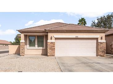 Charming single-story home featuring stone accents and a well-maintained front yard in a residential neighborhood at 28321 N Zircon Dr, San Tan Valley, AZ 85143