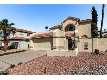 Charming two-story home with a two car garage, rock landscaping and tiled roof at 448 E Wescott Dr, Phoenix, AZ 85024