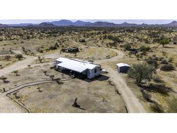 Expansive property featuring a charming home with mountain views and abundant desert landscape at 50525 W Whirly Bird Rd, Maricopa, AZ 85139