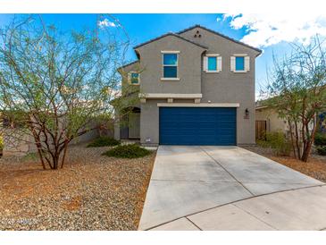Two-story home with a blue garage door, desert landscaping, and neutral paint scheme at 6823 W Getty Dr, Phoenix, AZ 85043
