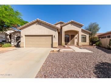 Charming single-story home featuring a two-car garage and low maintenance desert landscaping at 6970 W Paso Trl, Peoria, AZ 85383