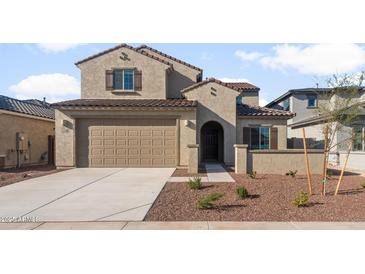 Charming two-story home featuring a neutral color palette, tile roof, and a two-car garage at 17788 W Getty Dr, Goodyear, AZ 85338