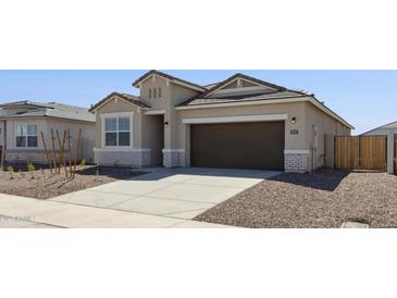 Beautiful single-story home with a two-car garage and a well-maintained front yard with desert landscaping at 18377 W Gray Fox Trl, Wittmann, AZ 85361