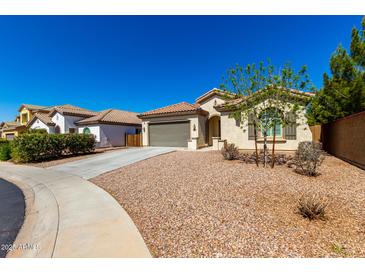 Attractive single-Gathering home featuring desert landscaping, a two-car garage, and a well-manicured front yard under a blue sky at 1980 E Horseshoe Dr, Chandler, AZ 85249