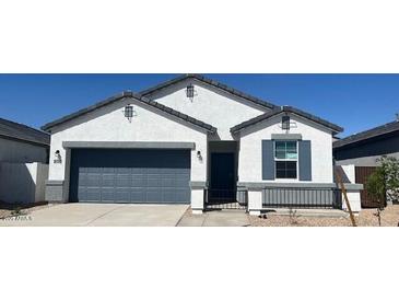 Charming single-story home featuring a two-car garage, low-maintenance landscaping, and a classic architectural design at 25356 W Sunland Ave, Buckeye, AZ 85326